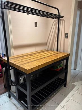 Mississauga (Lisgar) apartment for rent - A wooden top with black metal frame and shelves underneath.