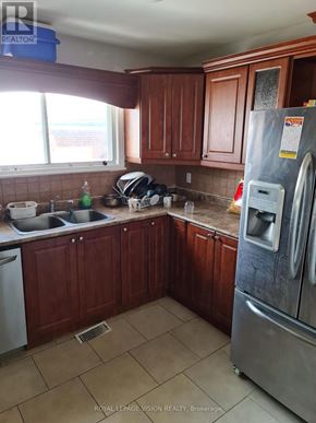 Toronto (Woburn) apartment for rent - A kitchen with brown cabinets and a stainless steel refrigerator.