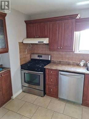 Toronto (Woburn) apartment for rent - A kitchen with brown cabinets and a stove top oven.