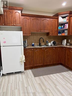Toronto (Woburn) apartment for rent - A kitchen with wooden cabinets and a white fridge.