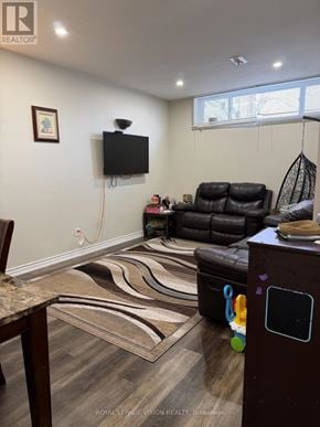 Toronto (Woburn) apartment for rent - A living room with a brown leather couch and a television on the wall.