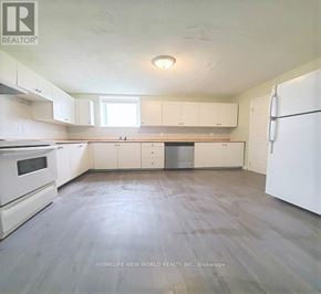Barrie (Georgian Drive) apartment for rent - A kitchen with white appliances and cabinets.