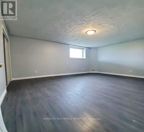Barrie (Georgian Drive) apartment for rent - A room with a window and wooden flooring.