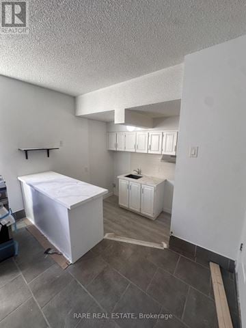 Toronto (South Parkdale) multi-family for rent - A kitchen under construction with a white cabinet and a white box on the floor.