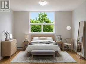 Toronto (Victoria Village) condo for rent - A bedroom with a bed, nightstand, and chair.