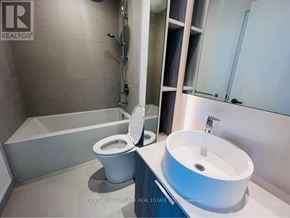 Mississauga (Port Credit) condo for rent - A bathroom with a toilet, sink, and bathtub.