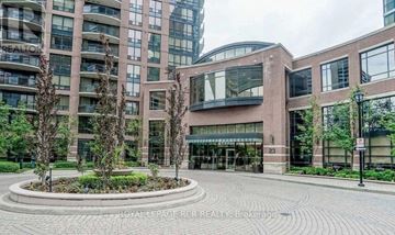 Toronto (Willowdale East) condo for rent - A large building with a circular garden in front.