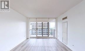 Toronto (Willowdale East) condo for rent - A white room with a door and a window with a view of a building.