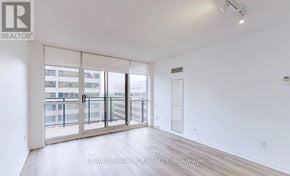 Toronto (Willowdale East) condo for rent - A white room with a sliding glass door leading to a balcony.