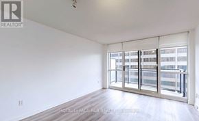 Toronto (Willowdale East) condo for rent - A white room with a sliding glass door leading to a balcony.