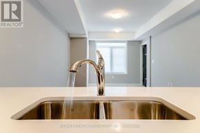 Kitchener townhouse for rent - A modern kitchen with a stainless steel sink and faucet.