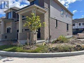 Kawartha Lakes (Lindsay) townhouse for rent - A modern house with a tree in front of it.
