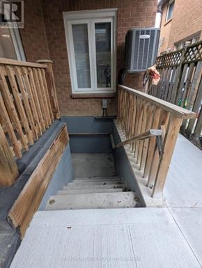 Mississauga (Hurontario) apartment for rent - A small staircase with a wooden railing leads to a basement.