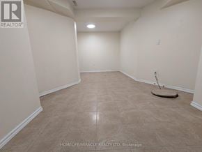 Mississauga (Hurontario) apartment for rent - Empty room with beige tiled floor and white walls.