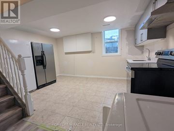 Mississauga (Hurontario) apartment for rent - A kitchen with a refrigerator, stove, and sink.