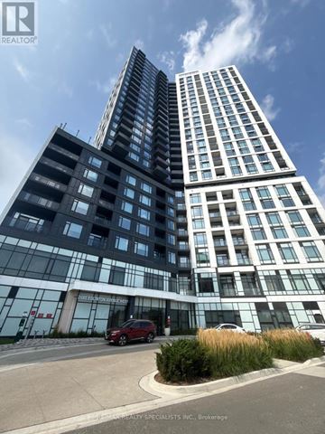 Mississauga (Central Erin Mills) condo for rent - A tall building with a glass facade is the main focus of the image.