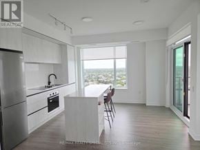 Mississauga (Central Erin Mills) condo for rent - A modern kitchen with a view of the city.