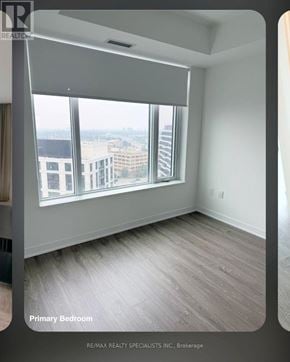 Mississauga (Central Erin Mills) condo for rent - A bedroom with a large window overlooking the city.