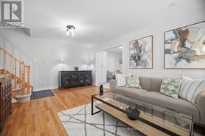Mississauga (Meadowvale Village) apartment for rent - A living room with a couch, coffee table, and staircase.