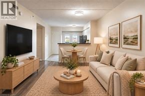 Milton condo for rent - A living room with a couch, a coffee table, a television, and a lamp.