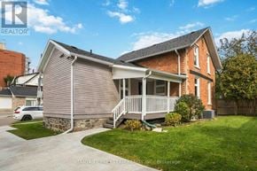 Oshawa (Central) apartment for rent - A house with a red brick chimney and a porch.
