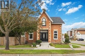 Oshawa (Central) apartment for rent - A brick house with a black front door is for sale.