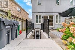 Mississauga (Meadowvale Village) apartment for rent - A grey building with a black gate in front of it.