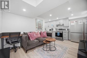 Mississauga (Meadowvale Village) apartment for rent - A living room with a grey couch and a wooden coffee table.