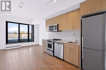 Toronto (Cliffcrest) condo for rent - A modern kitchen with wooden cabinets and stainless steel appliances.