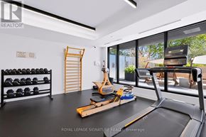 Toronto (Cliffcrest) condo for rent - A well-equipped home gym with a treadmill, weights, and exercise equipment.