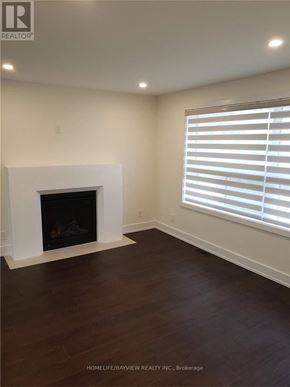 Vaughan (Maple) apartment for rent - A living room with a fireplace and wood flooring.