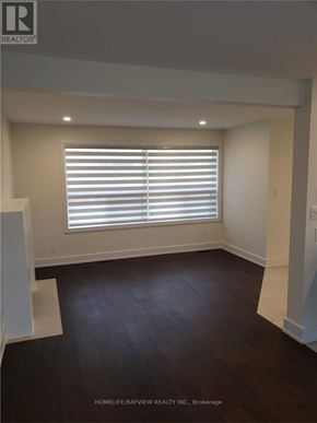 Vaughan (Maple) apartment for rent - A room with wooden floors and a window with blinds.