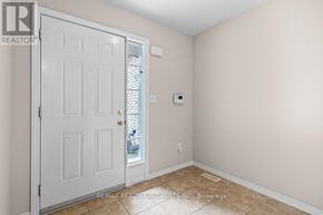 Kitchener townhouse for rent - A room with a white door and a window with a view of a balcony.