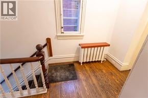 Hamilton apartment for rent - A room with a window, a radiator, and a wooden bench.