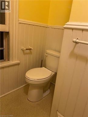 Hamilton apartment for rent - A white toilet in a bathroom with yellow walls.