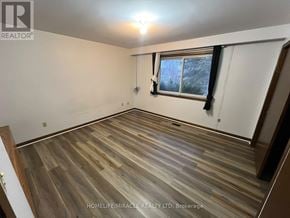 Brampton (Bram West) apartment for rent - A room with wooden flooring and a window with a view of snow outside.