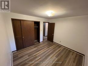 Brampton (Bram West) apartment for rent - A room with wooden flooring and a wall-mounted light fixture.