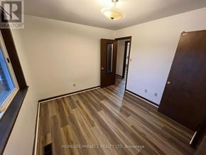 Brampton (Bram West) apartment for rent - A room with wooden flooring and a ceiling light fixture.