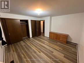 Brampton (Bram West) apartment for rent - A room with wooden flooring and white walls, with a light on the ceiling and a wooden bench against the wall.