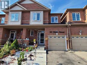Milton (Cl Clarke) townhouse for rent - A house with a red brick exterior and a white garage door.