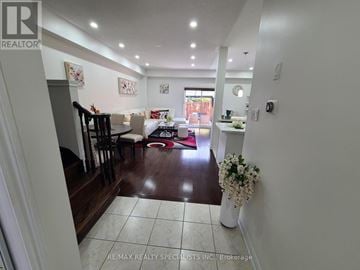 Milton (Cl Clarke) townhouse for rent - A living room with a white couch and a coffee table.