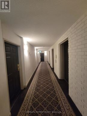 Ajax (Central West) condo for rent - A hallway with a patterned carpet and white walls.