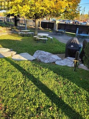 Ajax (Central West) condo for rent - A park with a picnic table and a tree.