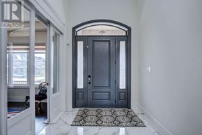 Vaughan (Kleinburg) apartment for rent - A black door with a glass window is in the middle of a hallway.