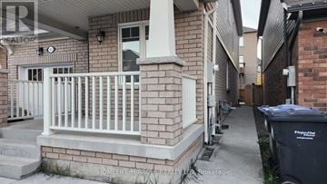 Brampton (Northwest Brampton) apartment for rent - A brick house with a white railing and a trash can.