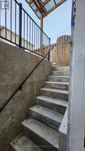 Brampton (Northwest Brampton) apartment for rent - A set of stairs with a metal railing and a wall with graffiti on it.