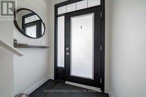 Burlington (Mountainside) townhouse for rent - A black door with a glass panel is in the center of the image.