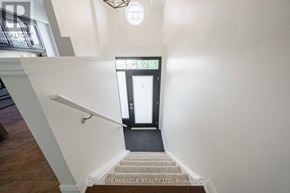 Burlington (Mountainside) townhouse for rent - A stairway with a black door at the bottom.