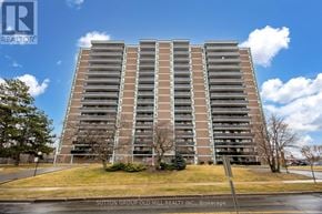 Toronto (Glenfield-Jane Heights) apartment for rent - A tall apartment building with a sign that says Sutton Group Old Mill Realty, Brokerage.