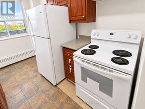 Toronto (Glenfield-Jane Heights) apartment for rent - A white stove and refrigerator in a kitchen.